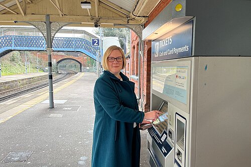 Zöe buying a train ticket